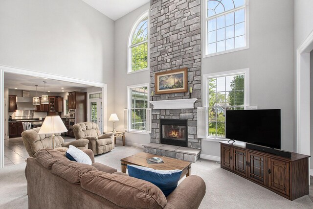 7251 Beverly Dr, South Haven, MI 49090 - living area featuring light colored carpet, a high ceiling, and a fireplace