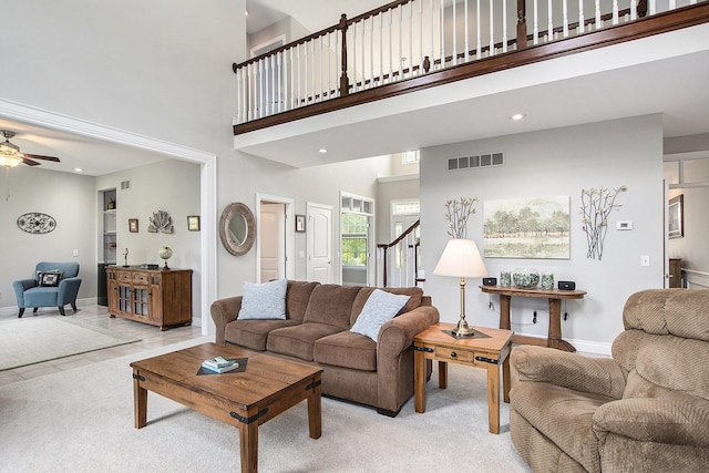 7251 Beverly Dr, South Haven, MI 49090 - living room with ceiling fan, stairway, a high ceiling, light colored carpet, and recessed lighting