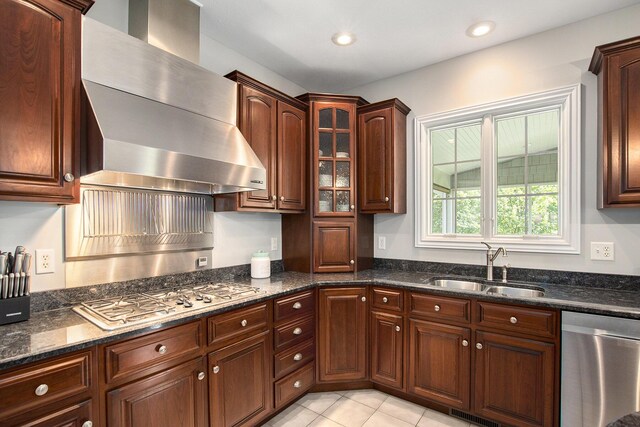 7251 Beverly Dr, South Haven, MI 49090 - kitchen with appliances with stainless steel finishes, wall chimney exhaust hood, dark stone countertops, glass insert cabinets, and light tile patterned flooring