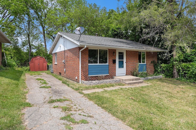 84 Eldred St, Battle Creek, MI 49015 - view of front of property featuring brick siding, a front lawn, driveway, and roof with shingles