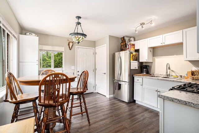84 Eldred St, Battle Creek, MI 49015 - kitchen featuring freestanding refrigerator, a sink, dark wood-type flooring, white cabinetry, and light countertops