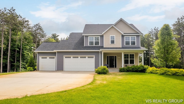 9340 Freedom Dr, West Olive, MI 49460 - view of front of house with concrete driveway, a front yard, a garage, a porch, and roof with shingles