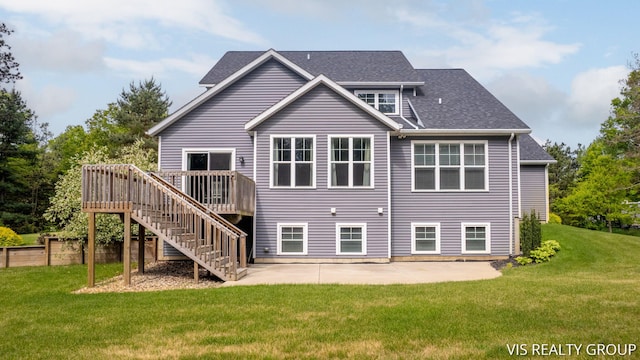 9340 Freedom Dr, West Olive, MI 49460 - back of property with stairs, a deck, a patio, and roof with shingles