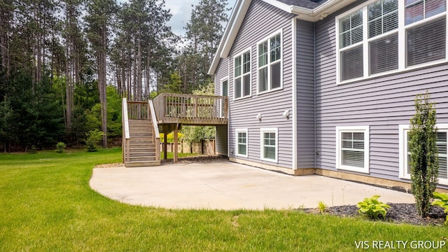 9340 Freedom Dr, West Olive, MI 49460 - view of property exterior featuring stairway, a yard, a patio, and a wooden deck