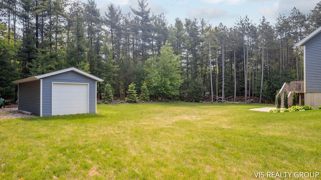 9340 Freedom Dr, West Olive, MI 49460 - view of grassy yard featuring a detached garage, an outbuilding, and stairs