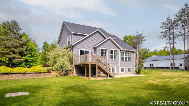 9340 Freedom Dr, West Olive, MI 49460 - back of property with stairs, a deck, a lawn, and roof with shingles