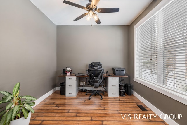9340 Freedom Dr, West Olive, MI 49460 - home office featuring light wood-style flooring, a ceiling fan, and baseboards
