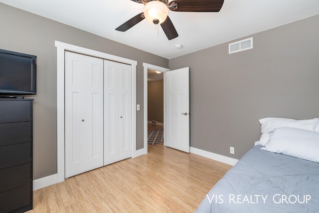 9340 Freedom Dr, West Olive, MI 49460 - bedroom with light wood-type flooring, baseboards, a closet, and ceiling fan