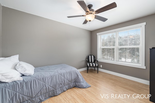 9340 Freedom Dr, West Olive, MI 49460 - bedroom with wood finished floors, baseboards, and ceiling fan