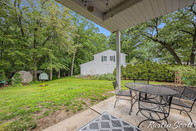 310 Brookgate Ct NW, Comstock Park, MI 49321 - view of patio featuring outdoor dining space and view of wooded area