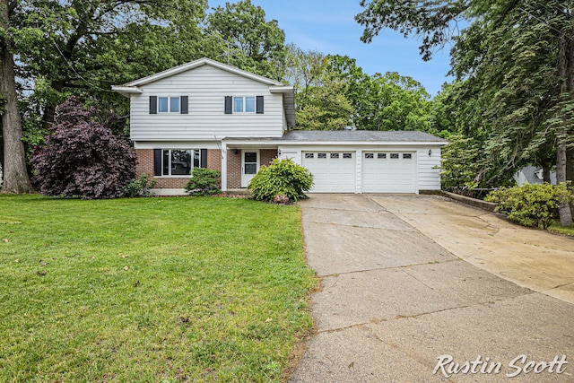 310 Brookgate Ct NW, Comstock Park, MI 49321 - traditional-style house featuring a garage, brick siding, concrete driveway, and a front lawn