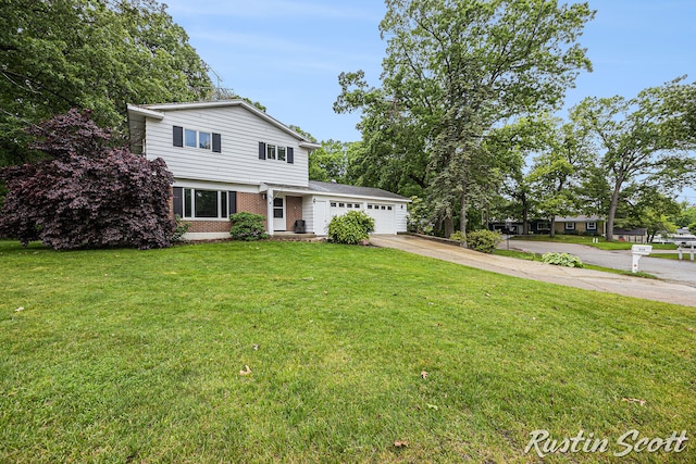 310 Brookgate Ct NW, Comstock Park, MI 49321 - traditional-style house with driveway, a garage, a front yard, and brick siding