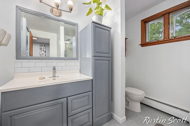 310 Brookgate Ct NW, Comstock Park, MI 49321 - full bath with a baseboard radiator, tasteful backsplash, baseboards, vanity, and toilet