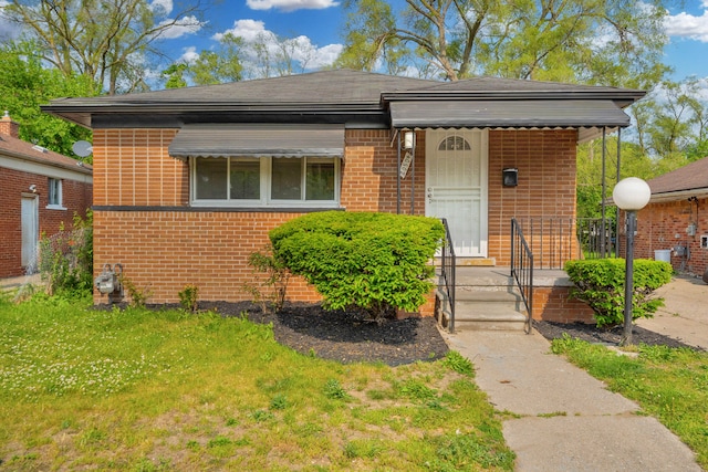 20504 Cherrylawn St, Detroit, MI 48221 - view of front of property featuring brick siding and a front lawn
