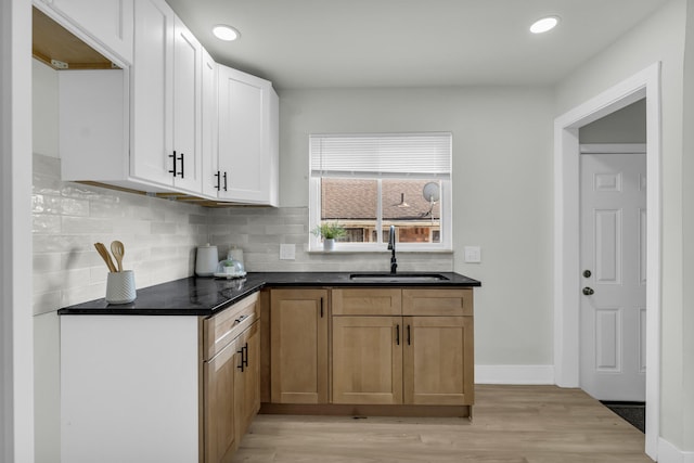 20504 Cherrylawn St, Detroit, MI 48221 - kitchen with a sink, light wood-type flooring, backsplash, recessed lighting, and dark countertops