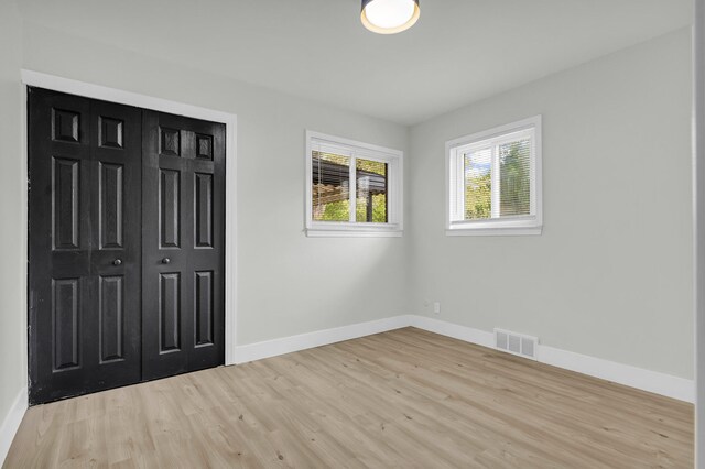 20504 Cherrylawn St, Detroit, MI 48221 - unfurnished bedroom with light wood-style flooring, baseboards, and a closet