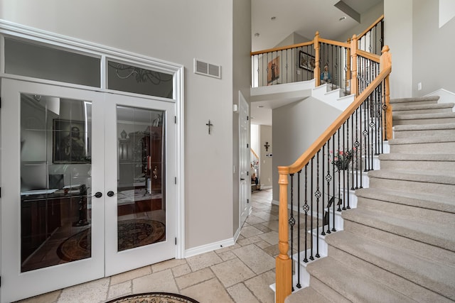 71 Knorrwood Dr, Rochester Hills, MI 48306 - entrance foyer featuring stone tile flooring, a towering ceiling, baseboards, stairway, and french doors