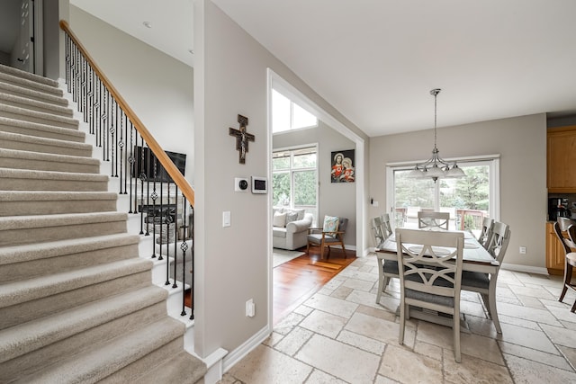 71 Knorrwood Dr, Rochester Hills, MI 48306 - dining space featuring stone tile flooring, stairway, and healthy amount of natural light