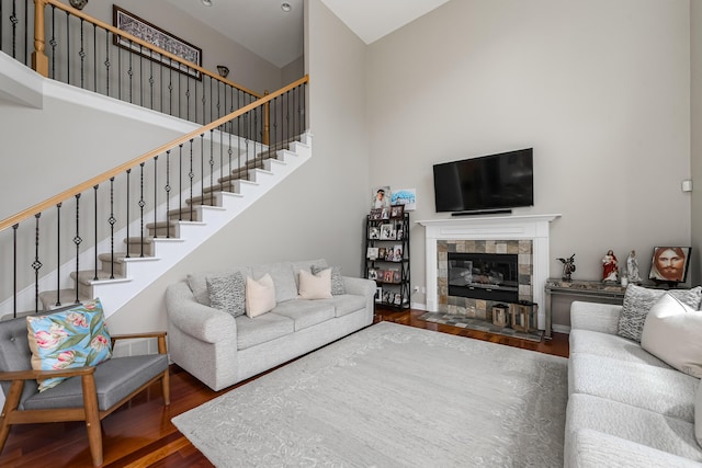 71 Knorrwood Dr, Rochester Hills, MI 48306 - living room featuring wood finished floors, stairs, a towering ceiling, and a tiled fireplace