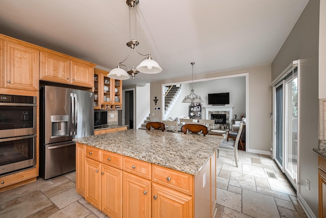 71 Knorrwood Dr, Rochester Hills, MI 48306 - kitchen with stainless steel appliances, stone tile flooring, a fireplace, and light stone countertops