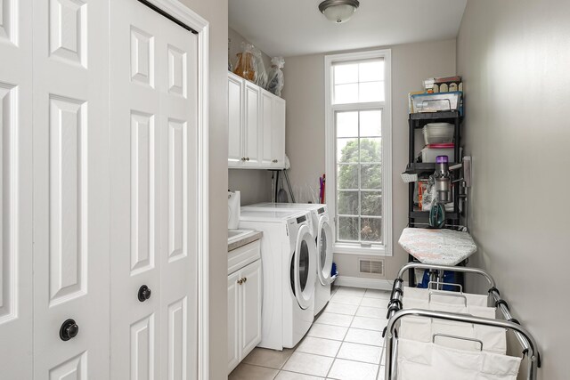 71 Knorrwood Dr, Rochester Hills, MI 48306 - laundry area featuring cabinet space, washer and dryer, light tile patterned floors, and baseboards
