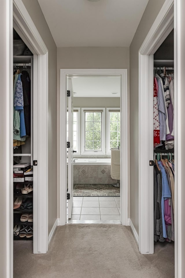 71 Knorrwood Dr, Rochester Hills, MI 48306 - hallway featuring carpet, tile patterned floors, and baseboards