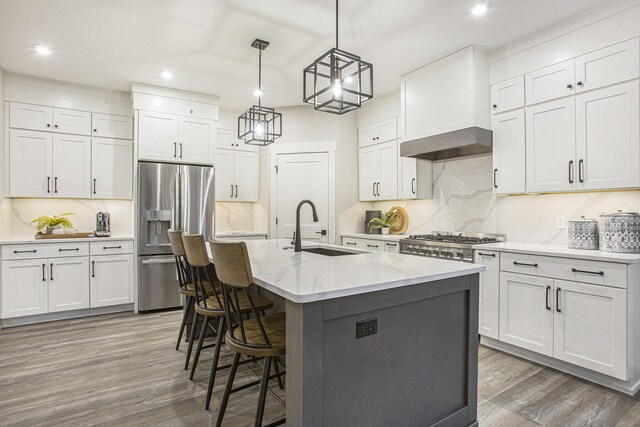 2740 Woodhaven Ct SW Unit 02, Byron Center, MI 49315 - kitchen with stainless steel fridge, a sink, recessed lighting, wood finished floors, and backsplash