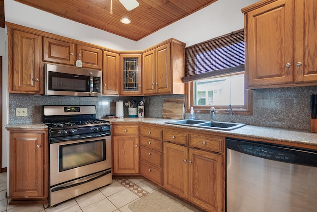 43 W Cherry Ave, Zeeland, MI 49464 - kitchen featuring stainless steel appliances, a sink, wooden ceiling, light tile patterned floors, and brown cabinets