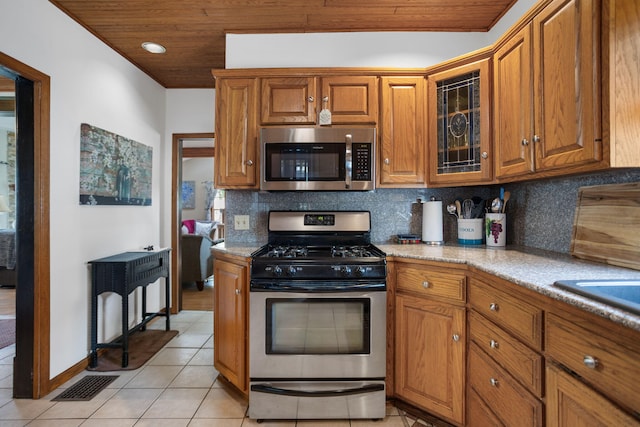 43 W Cherry Ave, Zeeland, MI 49464 - kitchen featuring appliances with stainless steel finishes, brown cabinets, light tile patterned floors, backsplash, and wood ceiling