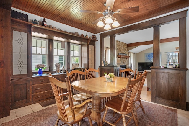 43 W Cherry Ave, Zeeland, MI 49464 - dining space featuring ceiling fan, light tile patterned floors, lofted ceiling, and a stone fireplace