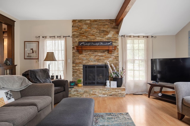 43 W Cherry Ave, Zeeland, MI 49464 - living area with wood finished floors, a fireplace, and beam ceiling