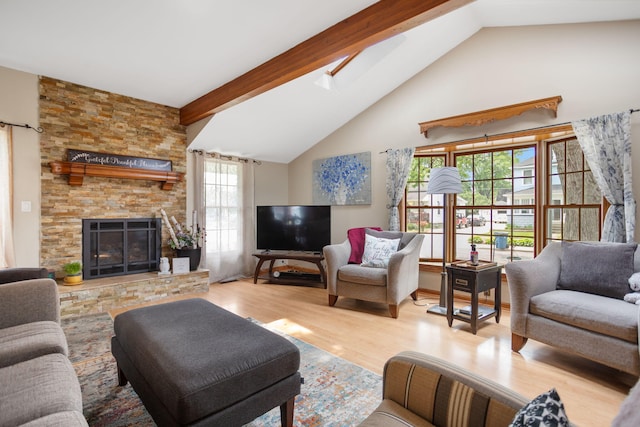 43 W Cherry Ave, Zeeland, MI 49464 - living room featuring wood finished floors, a skylight, beam ceiling, high vaulted ceiling, and a stone fireplace