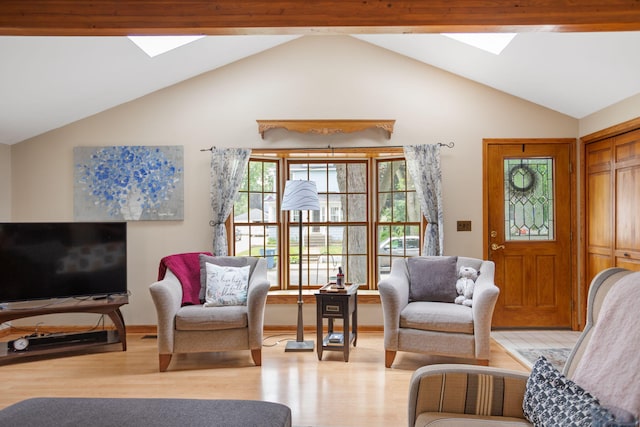 43 W Cherry Ave, Zeeland, MI 49464 - living room featuring a skylight, light wood-style floors, and vaulted ceiling