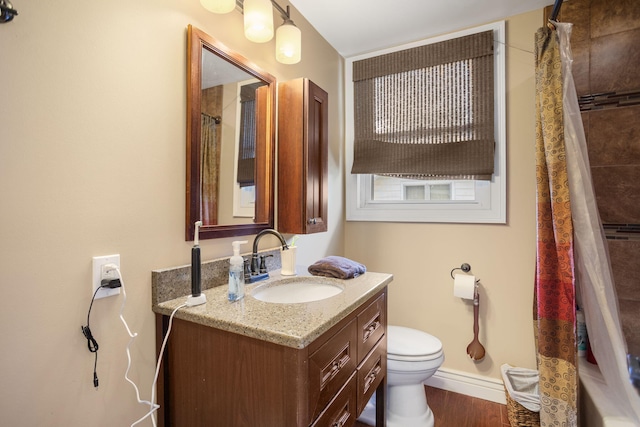 43 W Cherry Ave, Zeeland, MI 49464 - full bathroom featuring toilet, vanity, curtained shower, wood finished floors, and baseboards