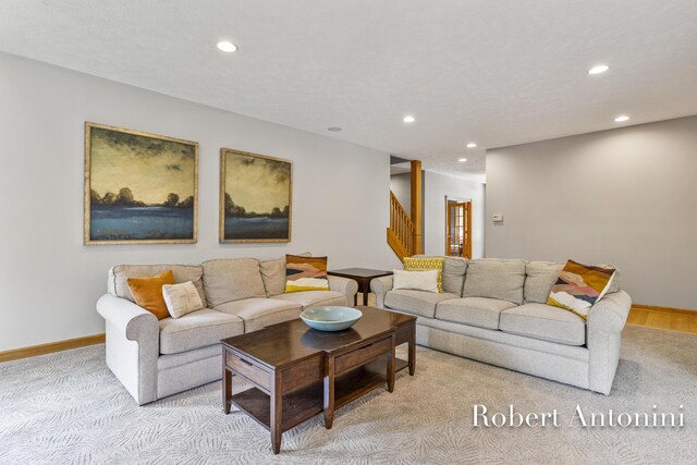 6374 Blakely Dr NE, Rockford, MI 49341 - living area featuring recessed lighting, stairs, light colored carpet, and baseboards