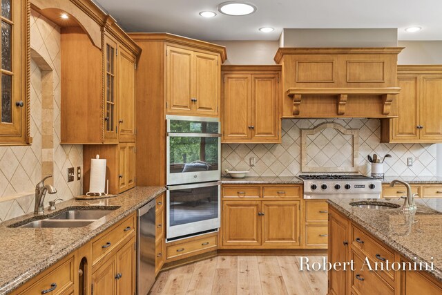 6374 Blakely Dr NE, Rockford, MI 49341 - kitchen with stainless steel appliances, a sink, light wood-style floors, decorative backsplash, and recessed lighting