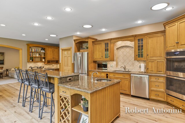 6374 Blakely Dr NE, Rockford, MI 49341 - kitchen with open shelves, appliances with stainless steel finishes, a sink, an island with sink, and recessed lighting