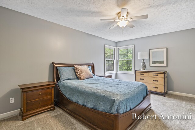 6374 Blakely Dr NE, Rockford, MI 49341 - bedroom featuring a textured ceiling, light colored carpet, baseboards, and ceiling fan