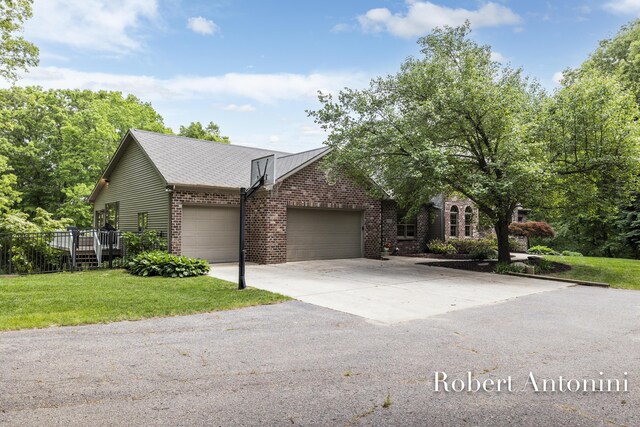 6374 Blakely Dr NE, Rockford, MI 49341 - view of front facade with a garage, brick siding, a front yard, and driveway