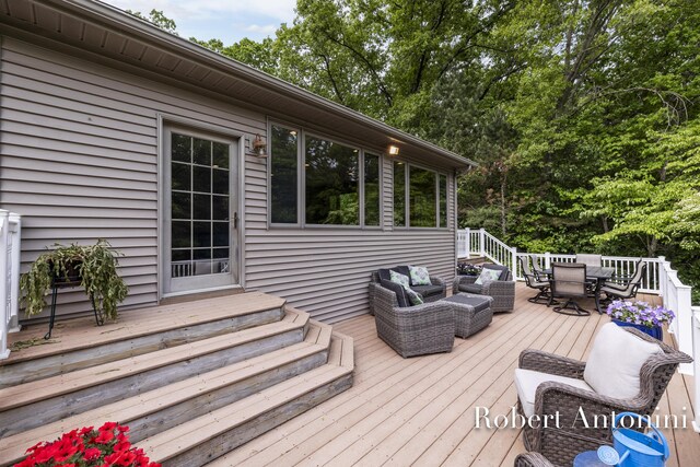6374 Blakely Dr NE, Rockford, MI 49341 - wooden terrace with outdoor dining space, outdoor lounge area, and view of scattered trees