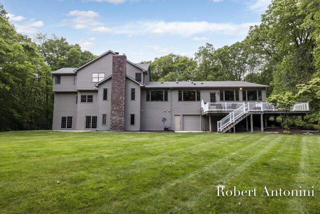 6374 Blakely Dr NE, Rockford, MI 49341 - back of property featuring a wooden deck, stairs, a garage, a lawn, and a chimney