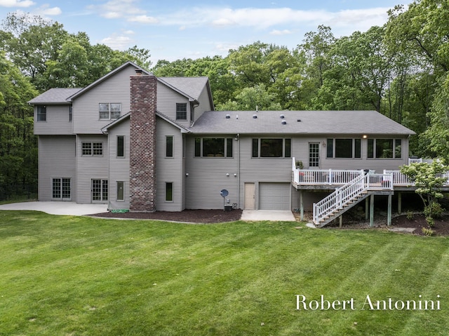 6374 Blakely Dr NE, Rockford, MI 49341 - back of house featuring a garage, stairway, a patio, and a lawn