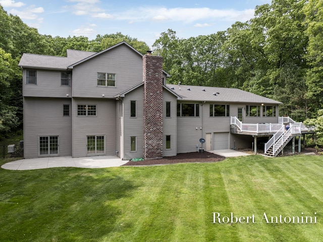 6374 Blakely Dr NE, Rockford, MI 49341 - rear view of house with a chimney, an attached garage, stairway, a yard, and a wooden deck