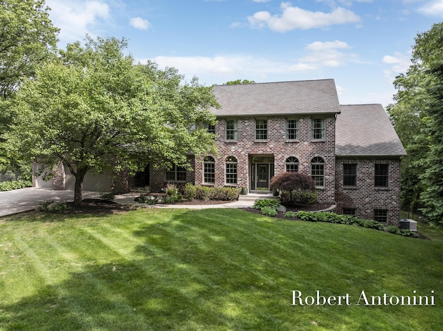 6374 Blakely Dr NE, Rockford, MI 49341 - view of front facade featuring brick siding, a front lawn, concrete driveway, and an attached garage