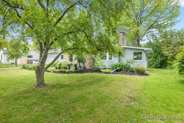 3020 Cascade Rd SE, Grand Rapids, MI 49506 - view of front of house featuring a front lawn and a chimney
