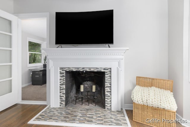 3020 Cascade Rd SE, Grand Rapids, MI 49506 - detailed view of a tiled fireplace, wood finished floors, and baseboards