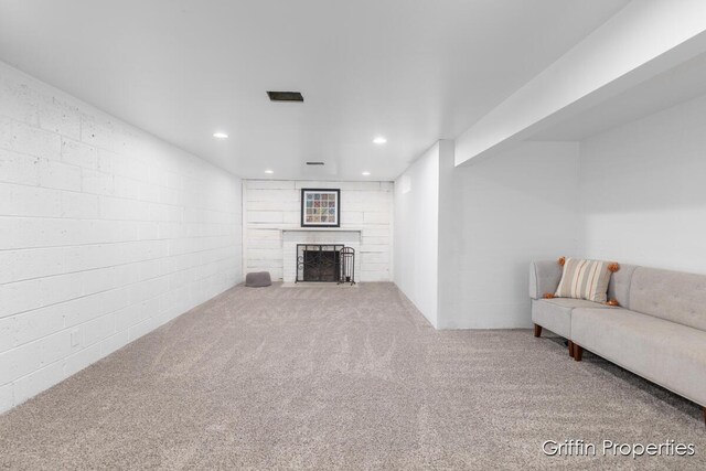 3020 Cascade Rd SE, Grand Rapids, MI 49506 - living room with a fireplace, recessed lighting, carpet, and concrete block wall