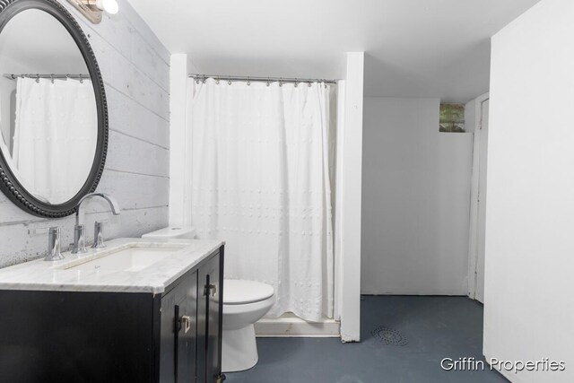 3020 Cascade Rd SE, Grand Rapids, MI 49506 - bathroom featuring concrete flooring, toilet, and vanity