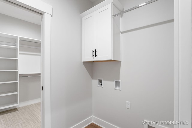 12607 76th Ave, Allendale, MI 49401 - washroom featuring cabinet space, hookup for a washing machine, baseboards, and carpet flooring