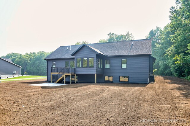 12607 76th Ave, Allendale, MI 49401 - rear view of property featuring stairway, a deck, and a shingled roof